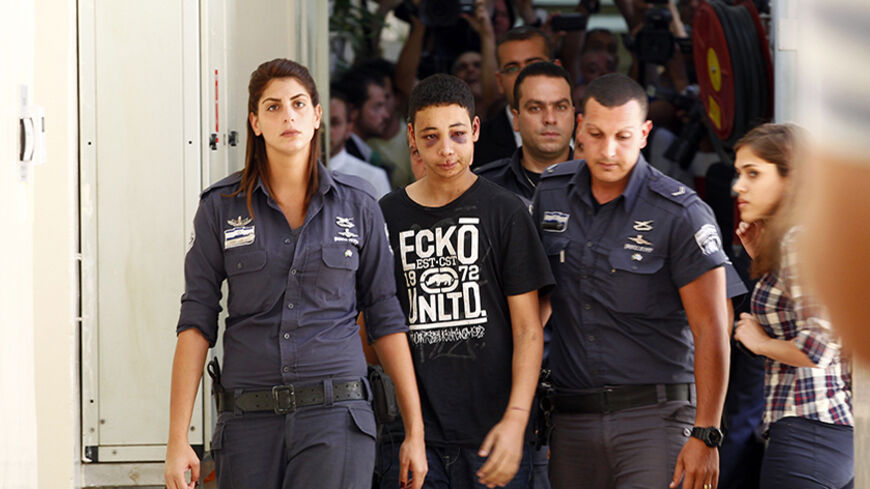 Tariq Khdeir (C), a 15-year-old American of Palestinian descent and a cousin of Mohammed Abu-Khdeir, the youth whom Palestinians believe was abducted and murdered by far-right Israelis on Wednesday, is escorted by Israeli prison guards during an appearance at Jerusalem magistrate's court July 6, 2014. The United States called for speedy investigation of an incident in which Khdeir appeared to have been badly beaten by Israeli paramilitary police during riots in East Jerusalem. A police spokesman said Khdeir