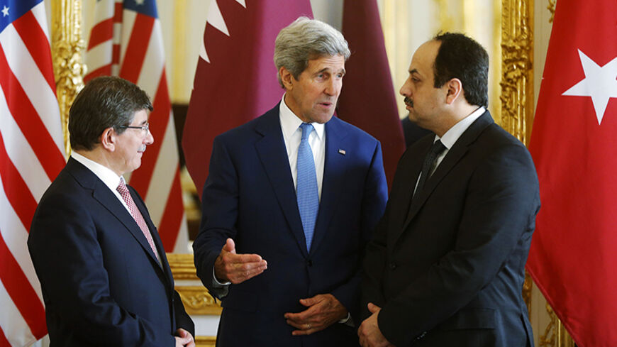 U.S. Secretary of State John Kerry (C), speaks with Qatari Foreign Minister Khaled al-Attiyah (R) and Turkish Foreign Minister Ahmet Davutoglu before they make statements to reporters during their meeting regarding a cease-fire between Hamas and Israel in Gaza, in Paris July 26, 2014. REUTERS/Charles Dharapak/Pool (FRANCE - Tags: POLITICS) - RTR407H7
