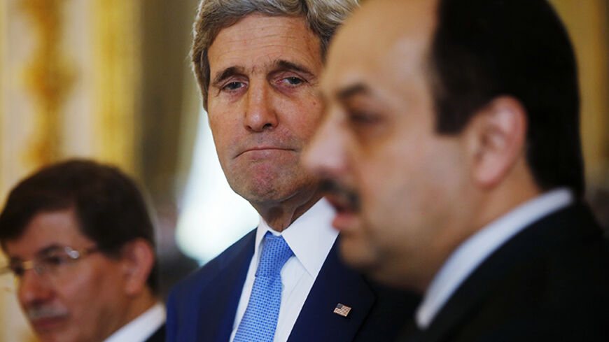 U.S. Secretary of State John Kerry (C), stands next to Qatari Foreign Minister Khaled al-Attiyah, (R) and Turkish Foreign Minister Ahmet Davutoglu as they make statements to reporters during their meeting regarding a cease-fire between Hamas and Israel in Gaza, at the U.S. ambassador's residence in Paris July 26, 2014. REUTERS/Charles Dharapak/Pool (FRANCE - Tags: POLITICS CIVIL UNREST) - RTR407J4