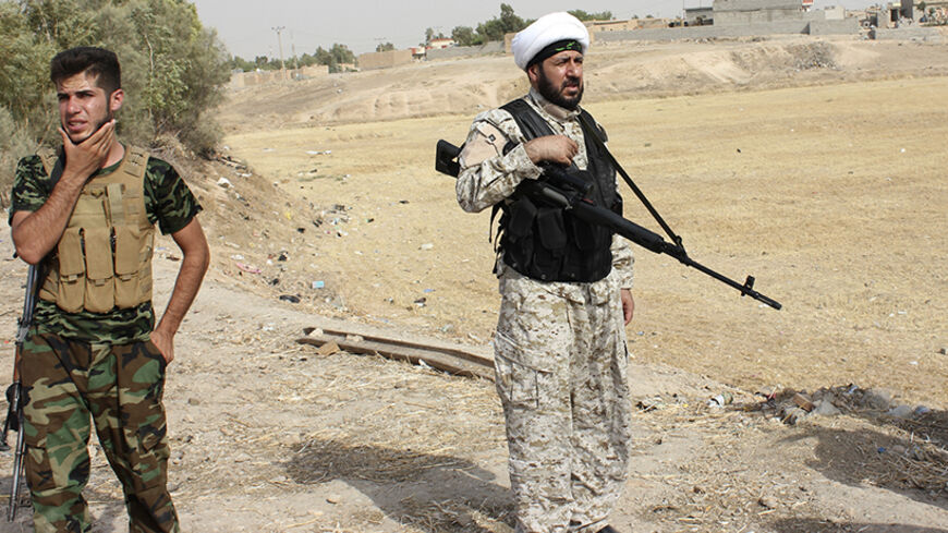 Armed tribal fighters take part in a mission to secure an area from militants of the Islamic State, formerly known as the Islamic State in Iraq and the Levant (ISIL), in the Hamrin mountains in Diyala province July 25, 2014. Picture taken July 25, 2014.  REUTERS/Stringer (IRAQ - Tags - Tags: CIVIL UNREST POLITICS) - RTR409ZG