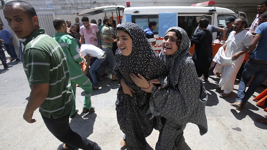 Palestinians react following what witnesses said was heavy Israeli shelling, at a hospital in Rafah in the southern Gaza Strip August 1, 2014.  A Gaza ceasefire crumbled only hours after it began on Friday, with at least 40 Palestinians killed by Israeli shelling and Israel accusing militants of violating the U.S.- and U.N.-brokered truce by firing rockets and mortars. The 72-hour break announced by U.S. Secretary of State John Kerry and U.N. Secretary-General Ban Ki-moon was the most ambitious attempt so f