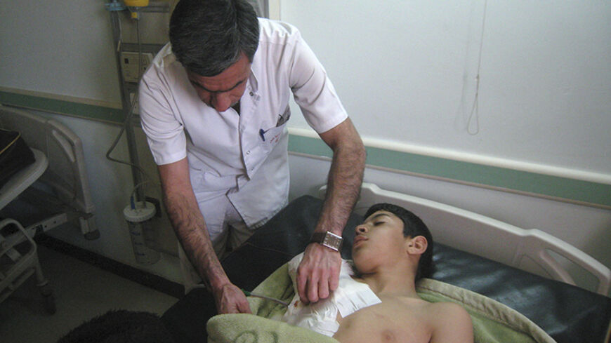 A boy receives treatment after being injured in a shelling, at a hospital in the city of Falluja, 70 km (43 miles) west of Baghdad February 12, 2014. ISIL militants and other Sunni groups angered by the Shi'ite-led government overran Falluja and parts of the nearby city of Ramadi in the western province of Anbar on January 1. REUTERS/Stringer (IRAQ - Tags: CIVIL UNREST POLITICS CONFLICT) - RTX18OUC