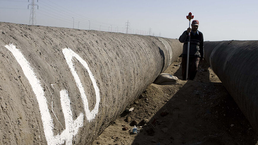 Workers build a pipeline for transporting natural gas to Israel in north Delta Nile, 300 km (186 miles) north of Cairo, November 23, 2008. A Cairo court on November 18, 2008 overruled the Egyptian government's decision to allow exports of natural gas to Israel and said the constitution gave parliament the right to decide on sales of natural resources. Gas started flowing to Israel through a pipeline for the first time in May under an agreement signed in 2005 for the supply of 1.7 billion cubic meters a year