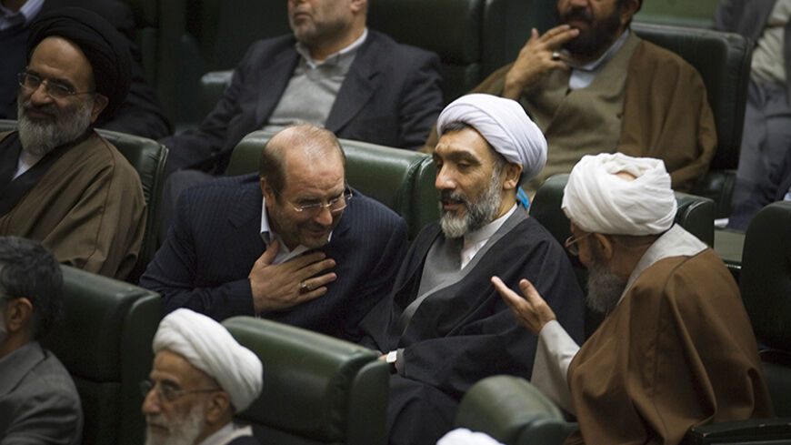 EDITORS' NOTE: Reuters and other foreign media are subject to Iranian restrictions on their ability to report, film or take pictures in Tehran.

An Iranian lawmaker welcomes Tehran Mayor Mohammad-Baqer Qalibaf (2nd L) at the Iranian Parliament during a ceremony to mark Parliament day in Tehran December 1, 2009. REUTERS/Morteza Nikoubazl (IRAN ANNIVERSARY POLITICS) - RTXRBH8