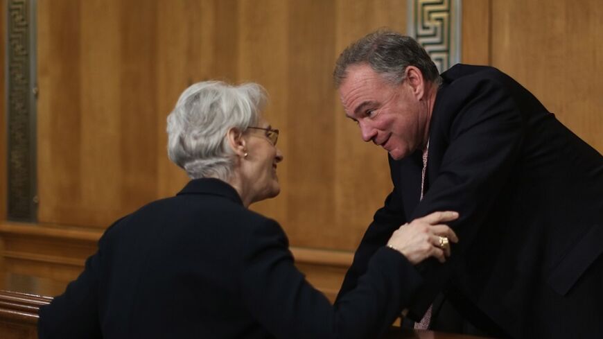 WASHINGTON, DC - JULY 29:  State Departent Undersecretary For Political Affairs Wendy Sherman (L) talks with Senate Foreign Relations Committee member Sen. Tim Kaine (D-VA) before she testifies to the committee about the ongoing P-5+1 talks with Iran during a hearing in the Dirksen Senate Office Building on Capitol Hill July 29, 2014 in Washington, DC. Many members of the committee are skeptical that the Obama Administration's agreement to extended talks with Iran for an additional four months will apply en