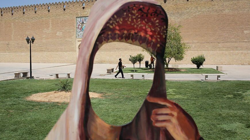 SHIRAZ, IRAN - MAY 29:  A cutout of a woman in Iranian dress stands in front of the Karim Khani Palace, also a former prison, on May 29, 2014 in Shiraz, Iran. Shiraz, celebrated for more than 2,000 years as the heartland of Persian culture, is known as the home of Iranian poetry and for its progressive attitudes and tolerance. Like all of Iran, this week Shiraz observes the 25th anniversary of the death and continued legacy of the Ayatollah Khomeini, the father of the Islamic revolution.  (Photo by John Moo