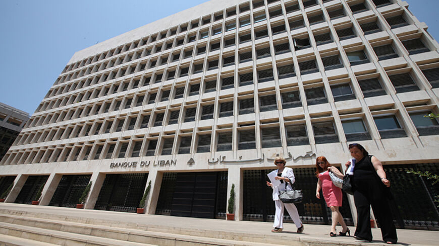 People are seen leaving Lebanon's Central Bank in Beirut July 7, 2011. Lebanese banks which worked for years to build up business in neighbouring Syria have been quietly implementing U.S. and European Union sanctions against Damascus to avoid jeopardising their international operations, bankers and economists say. Picture taken July 7, 2011. To match Feature LEBANON-SYRIA/BANKS   REUTERS/Mohamed Azakir    (LEBANON - Tags: BUSINESS) - RTR2XHQQ