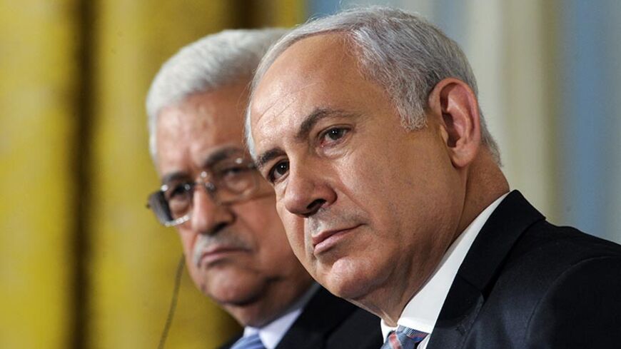 Palestinian President Mahmoud Abbas (L) sits next to Israeli Prime Minister Benjamin Netanyahu, as leaders gathered to deliver a joint statement on Middle East Peace talks in the East Room of the White House in Washington September 1, 2010.     REUTERS/Jonathan Ernst (UNITED STATES - Tags: POLITICS IMAGES OF THE DAY) - RTR2HTF7