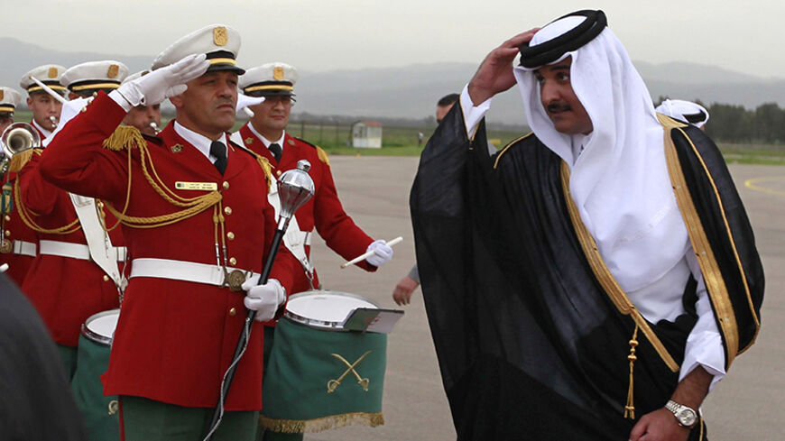 Qatar's Emir Sheikh Tamim bin Hamad al-Thani reviews honour guards during a welcoming ceremony at Algiers airport April 2, 2014. REUTERS/Louafi Larbi (ALGERIA - Tags: POLITICS) - RTR3JOO5