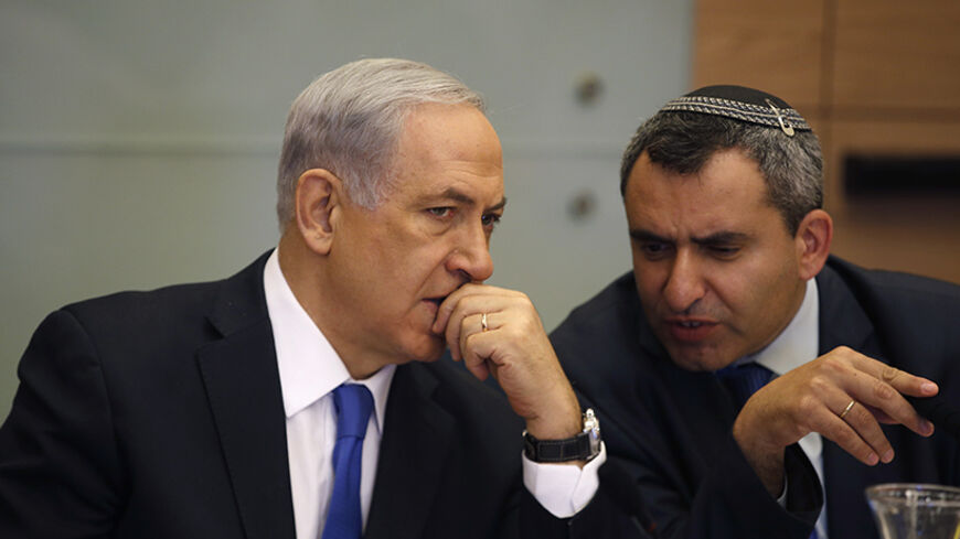 Israel's Prime Minister Benjamin Netanyahu (L) listens to Foreign Affairs and Defence committee chair Zeev Elkin during a committee meeting at parliament in Jerusalem June 2, 2014. Netanyahu warned on Sunday against any international rush to recognise a Palestinian government due to be announced under a unity pact between the Fatah and Hamas Islamist groups.REUTERS/Ronen Zvulun (JERUSALEM - Tags: POLITICS) - RTR3RRU6