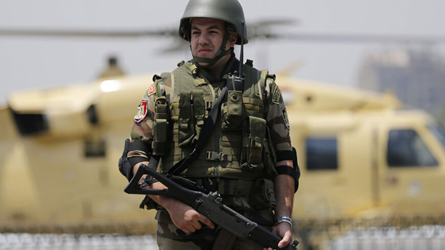 A member of the presidential guards a military helicopter of former army chief Abdel Fattah al-Sisi as he boards it after swearing in as Egypt's new president in a ceremony at the Supreme Constitutional Court in Cairo June 8, 2014. Sisi was sworn in as president of Egypt on Sunday in a ceremony with low-key attendance by Western allies concerned by a crackdown on dissent since he ousted Islamist leader Mohamed Mursi last year. REUTERS/Amr Abdallah Dalsh  (EGYPT - Tags: POLITICS) - RTR3SQ85