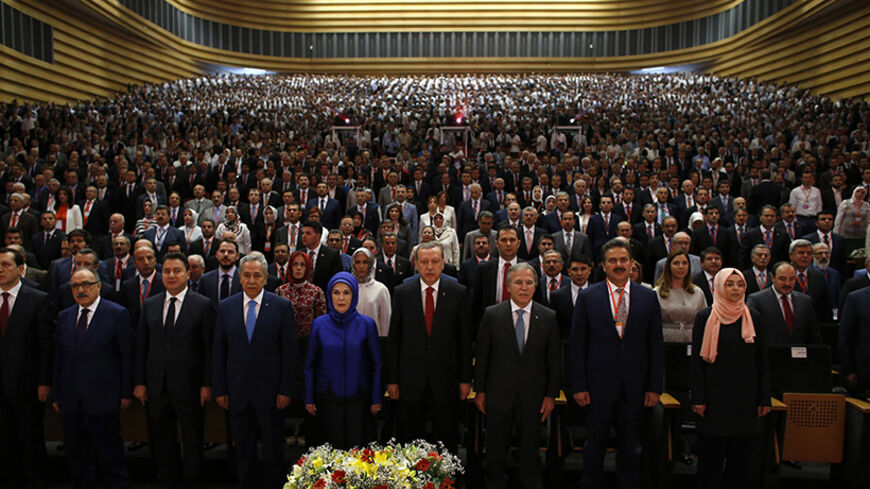 Turkey's Prime Minister Tayyip Erdogan (C), his family and AK Party (AKP) members attend a meeting where he is named as his party's candidate for the country's first direct presidential election in Ankara July 1, 2014. Tayyip Erdogan declared his candidacy on Tuesday for a more powerful presidency which rivals fear may entrench authoritarian rule and supporters, especially conservative Muslims, see as the crowning prize in his drive to reshape NATO member Turkey. REUTERS/Umit Bektas (TURKEY - Tags: POLITICS