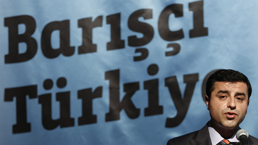 Selahattin Demirtas, co-chairman of the pro-Kurdish Peoples' Democracy Party (HDP) and presidential candidate, makes a speech during a meeting to launch his election campaign in Istanbul July 15, 2014. The first round of voting in presidential election will be held on August 10. Slogan on the banner partly reads that: "Peaceful Turkey" REUTERS/Murad Sezer (TURKEY - Tags: POLITICS ELECTIONS) - RTR3YQ3O