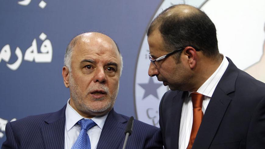 Salim al-Jabouri (R), new speaker of the Iraqi Council of Representatives, and Shi'ite deputy speaker Haider Abadi (L), a member of Iraqi Prime Minister Nuri al-Maliki's State of Law bloc, speak during a news conference in Baghdad, July 15, 2014. Iraqi politicians named Jabouri, a moderate Sunni Islamist, as speaker of parliament on Tuesday, a long-delayed first step towards a power-sharing government urgently needed to save the state from disintegration in the face of a Sunni uprising. REUTERS/Ahmed Saad (