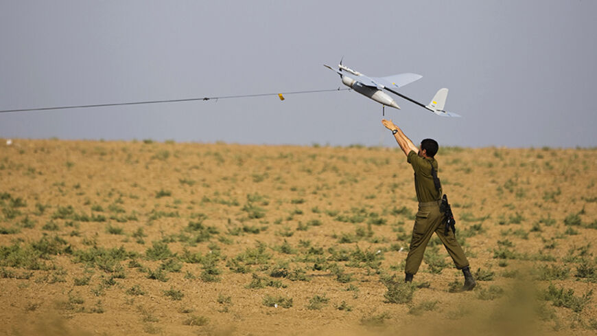 An Israeli soldier launches a drone outside the Gaza Strip July 22, 2014. Israel pounded targets across the Gaza Strip on Tuesday, saying no ceasefire was near as top U.S. and U.N. diplomats pursued talks on halting fighting that has claimed more than 600 lives. With the conflict entering its third week, the Palestinian death toll rose to 603, including nearly 100 children and many other civilians, Gaza health officials said. Israel's casualties also mounted, with the military announcing the deaths of two m