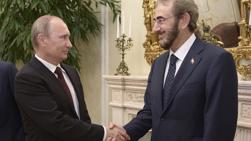 Russia's President Vladimir Putin shakes hands with Iraq's acting Defence Minister Saadoun al-Dulaimi (R) during a meeting in Moscow July 27, 2014 in this handout provided by Iraq Ministry of Defence. Picture taken July 27, 2014. REUTERS/Iraq Ministry of Defence/Handout via Reuters (RUSSIA - Tags: POLITICS MILITARY) ATTENTION EDITORS - THIS PICTURE WAS PROVIDED BY A THIRD PARTY. REUTERS IS UNABLE TO INDEPENDENTLY VERIFY THE AUTHENTICITY, CONTENT, LOCATION OR DATE OF THIS IMAGE. FOR EDITORIAL USE ONLY. NOT F