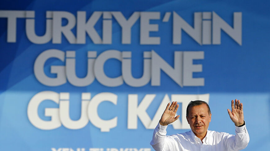 Turkey's Prime Minister and presidential candidate Tayyip Erdogan (C) greets his supporters during an election rally in Istanbul August 3, 2014. Turkey will vote for its first directly-elected president on August 10. The slogan in the background taht reads: "Add more strength to Turkey's power" REUTERS/Murad Sezer (TURKEY - Tags: POLITICS ELECTIONS) - RTR41360