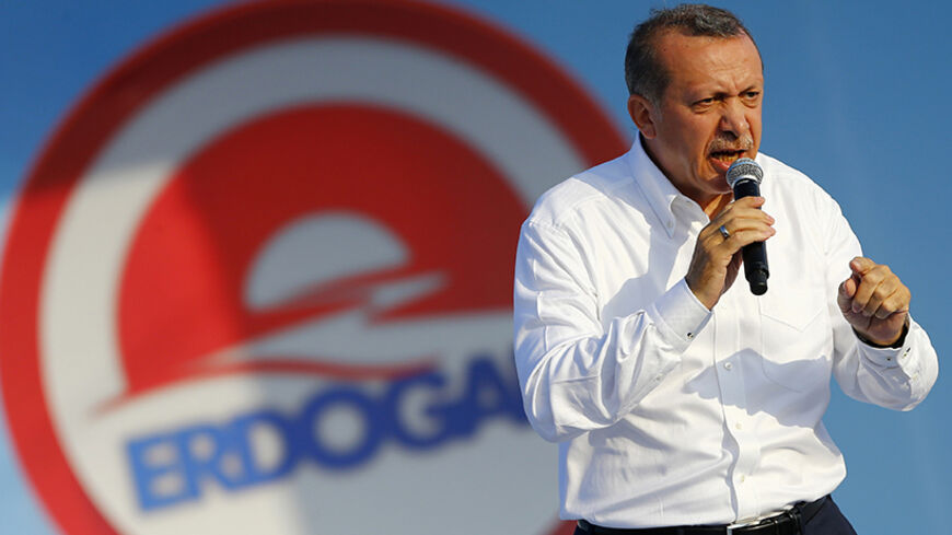 Turkey's Prime Minister and presidential candidate Tayyip Erdogan addresses his supporters during an election rally in Istanbul August 3, 2014. Cheers erupted from the packed stands when Erdogan scored his third goal in a celebrity soccer match to mark the opening of an Istanbul stadium. His orange jersey bore the number 12, a reminder of Erdogan's ambition to become the nation's 12th president in Turkey's first popular vote for its head of state, on Aug. 10. After dominating Turkish politics for more than 