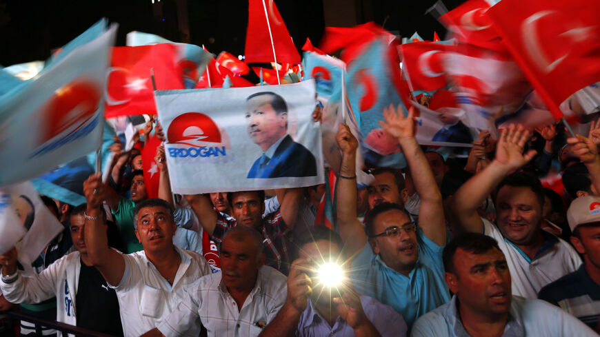 Supporters of Turkey's Prime Minister Tayyip Erdogan celebrate his election victory in front of the party headquarters in Ankara August 10, 2014. Erdogan secured his place in history as Turkey's first directly elected president on Sunday, sweeping more than half the vote in a result his opponents fear heralds an increasingly authoritarian state. REUTERS/Murad Sezer (TURKEY  - Tags: POLITICS ELECTIONS)   - RTR41WCA