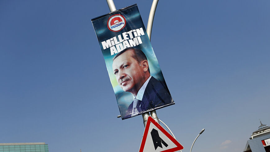 A presidential election campaign banner of Turkey's Prime Minister Tayyip Erdogan, with a slogan that reads "Man of the nation", hangs on a street near his ruling AK Party headquarters in Ankara August 11, 2014. Turkey's ruling party begins deliberations on the shape of the next government on Monday after Erdogan secured his place in history by winning the nation's first direct presidential election. Erdogan's victory in Sunday's vote takes him a step closer to the executive presidency he has long coveted f