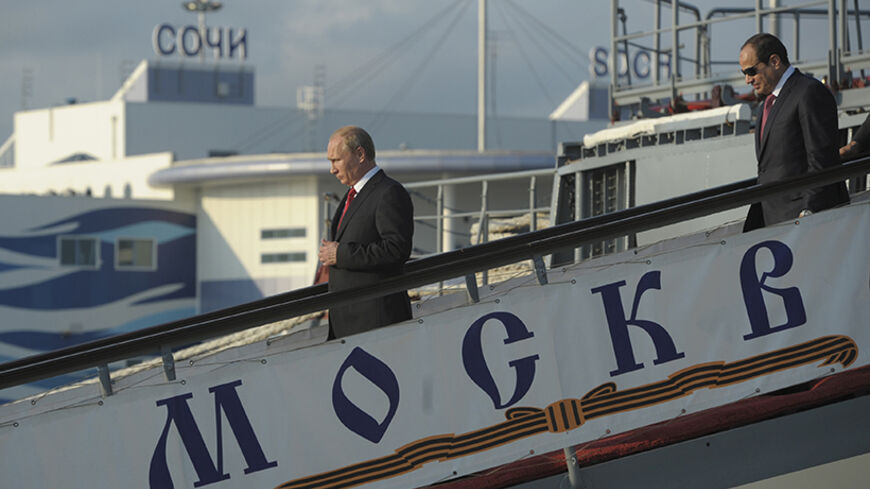 Russia's President Vladimir Putin (L) and his Egyptian counterpart Abdel Fattah al-Sisi leave the guided missile cruiser Moskva at the Black Sea port of Sochi, August 12, 2014.  REUTERS/Alexei Druzhinin/RIA Novosti/Kremlin (RUSSIA  - Tags: POLITICS MILITARY) ATTENTION EDITORS - THIS IMAGE HAS BEEN SUPPLIED BY A THIRD PARTY. IT IS DISTRIBUTED, EXACTLY AS RECEIVED BY REUTERS, AS A SERVICE TO CLIENTS - RTR4266Z
