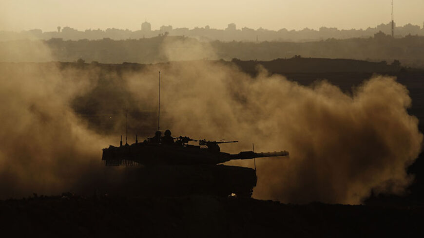 An Israeli tank patrols just outside the border with the northern Gaza Strip August 12, 2014. Talks to end a month-long war between Israel and Gaza militants are "difficult", Palestinian delegates said on Tuesday, while Israeli officials said no progress had been made so far and fighting could soon resume. REUTERS/ Amir Cohen (ISRAEL - Tags: POLITICS CIVIL UNREST MILITARY TPX IMAGES OF THE DAY) - RTR4269F