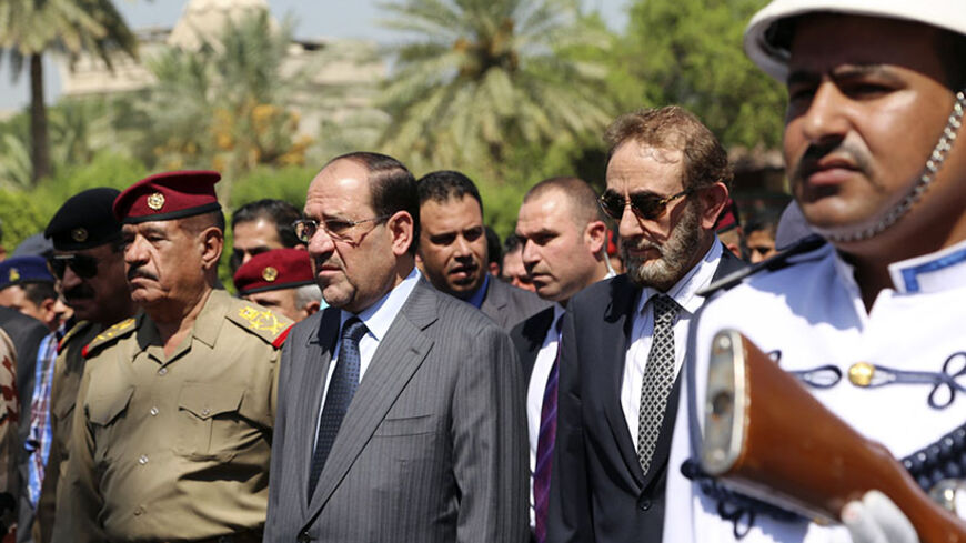 Nuri al-Maliki (C), acting Defence Minister Saadoun al-Dulaimi (2nd R) and Lieutenant General Abboud Qanbar (L) attend the funeral ceremony of Gen. Majid Abdul Salam, at the defence ministry in Baghdad August 13, 2014. Gen. Majid Abdul Salam was the pilot of the Iraqi army helicopter carrying aid and evacuating displaced members of the Yazidi minority in northern Iraq that crashed on Tuesday, in an accident that also wounded passengers, a government spokesman said.  REUTERS/Stringer (IRAQ - Tags: CIVIL UNRE