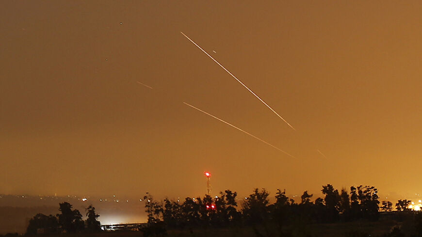 Light streaks and trails are seen as rockets are launched from Gaza towards Israel before a 72-hour cease fire was due to expire August 13, 2014. At least two rockets fired from the Gaza Strip struck Israel on Wednesday, moments before a three-day truce was set to expire, police said. Spokesman Micky Rosenfeld said two rockets landed in open areas causing no damage or casualties. The attacks occurred as Palestinians announced agreement to extend a truce expiring at 2100 gmt Wednesday for another five days. 