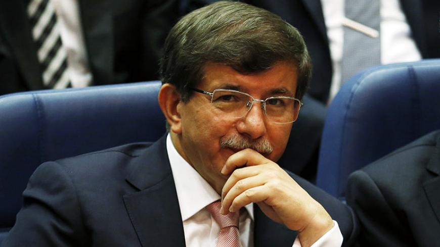 Turkey's Foreign Minister Ahmet Davutoglu attends a meeting at AK Party (AKP) headquarters in Ankara August 14, 2014. Turkish president-elect Tayyip Erdogan urged his ruling AK Party on Thursday to work for a stronger parliamentary majority next year to enable them to re-write the constitution, signalling no let-up in his drive to create an executive presidency. REUTERS/Umit Bektas (TURKEY - Tags: POLITICS) - RTR42E5X