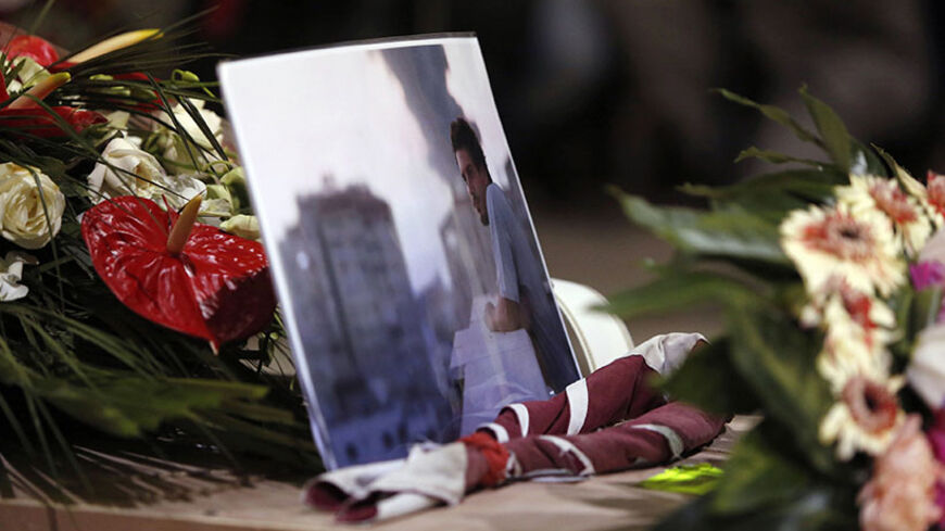 A picture of Associated Press video journalist Simone Camilli, who was killed Wednesday in an explosion in Gaza, is seen during his funeral ceremony at the Pitigliano Cathedral in Tuscany, August 15, 2014. Camilli, 35, a video journalist working for the Associated Press, was the first international journalist killed in the latest Gaza conflict. REUTERS/Riccardo De Luca/Pool (ITALY - Tags: MEDIA POLITICS OBITUARY CONFLICT) - RTR42L2M