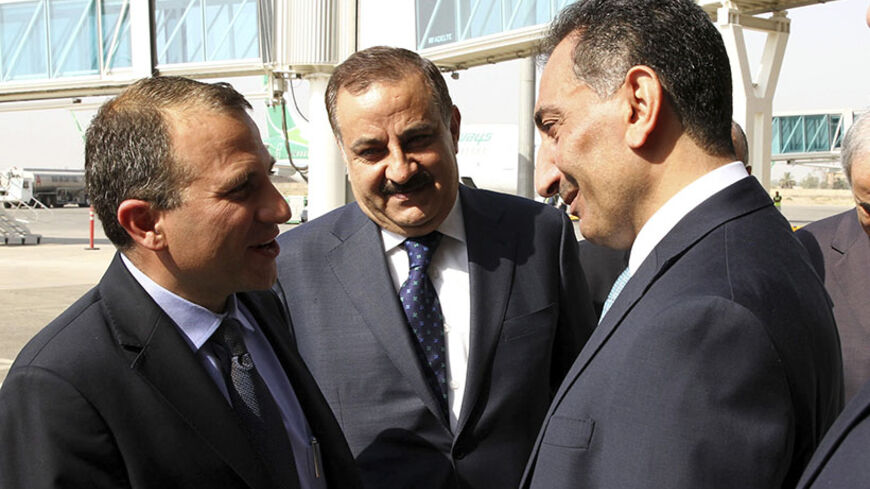 Iraqi Deputy Foreign Minister Nizar al-Khairallah (R) greets Lebanon's Foreign Minister Gebran Bassil (L) at the Baghdad airport in Baghdad, August 18, 2014. REUTERS/Ali Abbas/Pool (IRAQ - Tags: POLITICS) - RTR42T21