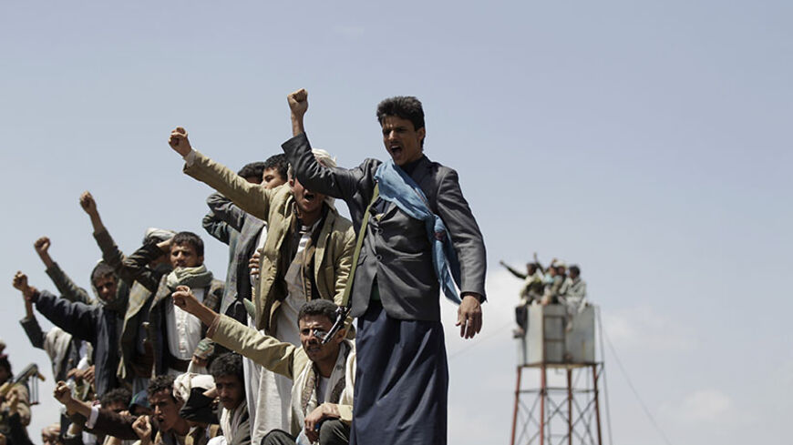 Followers of the Shi'ite Houthi group shout slogans during a gathering near the Yemeni capital Sanaa August 20, 2014. Countries trying to save Yemen from falling apart at the hands of Islamist militants and separatist movements warned Shi'ite Muslim Houthis on Tuesday to stop trying to gain territory by force and engage in a political transition process. REUTERS/Khaled Abdullah (YEMEN - Tags: POLITICS CIVIL UNREST) - RTR4340W