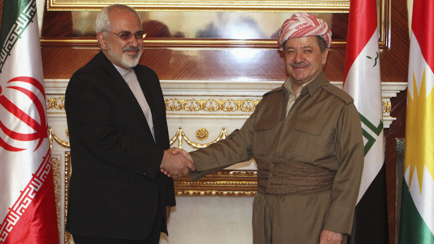Iraqi Kurdish regional President Masoud Barzani (R) shakes hands with Iranian foreign minister Mohammad Javad Zarif in Arbil, north of Baghdad, August 26, 2014. Iran supplied weapons and ammunition to Iraqi Kurdish forces, Kurdistan President Barzani said Tuesday at a joint news conference with Iranian foreign minister Zarif in Arbil, capital of Iraq's autonomous Kurdish region.  REUTERS/Azad Lashkari (IRAQ - Tags: POLITICS CONFLICT CIVIL UNREST TPX IMAGES OF THE DAY) - RTR43TA5