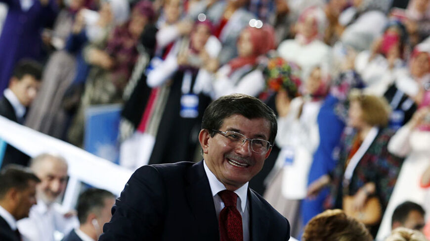 Turkey's Foreign Minister Ahmet Davutoglu greets his supporters during the Extraordinary Congress of the ruling AK Party (AKP) to choose a new leader of the party, ahead of his inauguration as president, in Ankara August 27, 2014. Davutoglu was elected leader of Turkey's ruling AK Party on Wednesday in a televised ceremony, ahead of his expected appointment as prime minister on Thursday after Tayyip Erdogan is sworn in as president.
  REUTERS/Umit Bektas (TURKEY - Tags: POLITICS) - RTR43ZK6