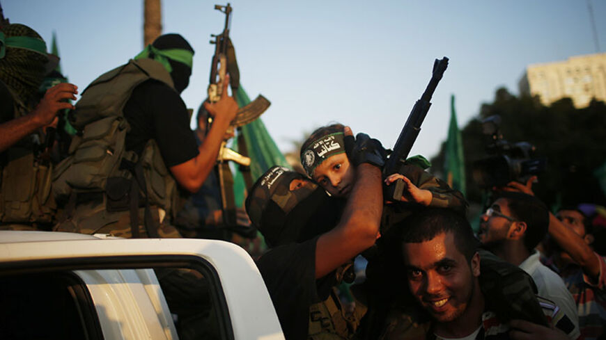 Hamas militants celebrate with people in what they said was a victory over Israel, in Gaza City August 27, 2014. An open-ended ceasefire in the Gaza war held on Wednesday as Prime Minister Benjamin Netanyahu faced strong criticism in Israel over a costly conflict with Palestinian militants in which no clear victor emerged. 
REUTERS/Mohammed Salem (GAZA - Tags: CIVIL UNREST CONFLICT POLITICS) - RTR43ZYV