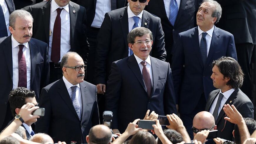 Turkish Prime Minister Ahmet Davutoglu greets his supporters as he leaves Kocatepe Mosque after Friday prayers in Ankara August 29, 2014. Davutoglu announced a new cabinet on Friday keeping key members of the economic management team in place and appointing the man who has managed Ankara's affairs with Europe as foreign minister. REUTERS/Umit Bektas (TURKEY - Tags: POLITICS) - RTR448EI