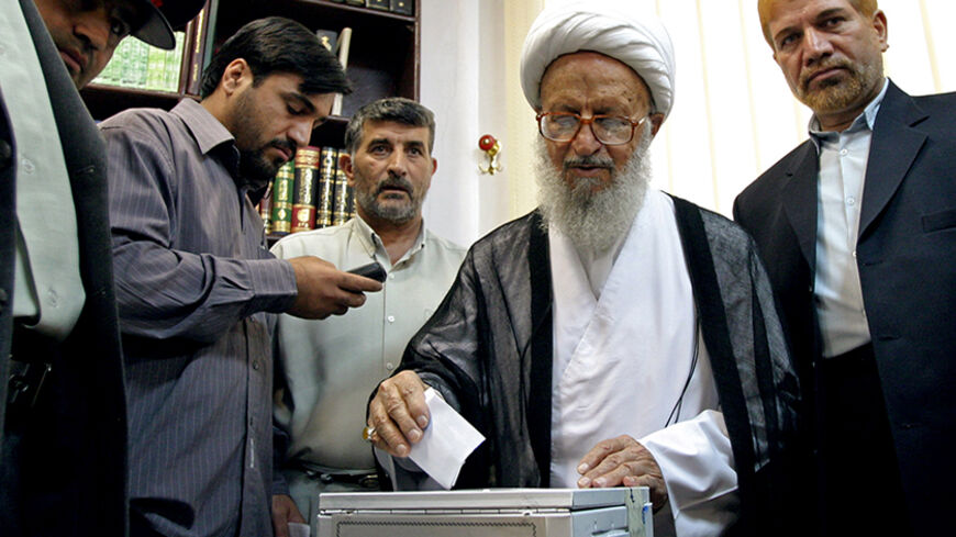 Grand Ayatollah Makarem Shirazi (2nd R) casts his vote in Qom, 120 km (75 miles) south of Tehran, June 17, 2005. Iranians began voting for a new president on Friday, with wily pragmatist cleric Akbar Hashemi Rafsanjani the front-runner in an unusually tight election denounced by the United States as unfair. REUTERS/Morteza Nikoubazl  MN/TZ - RTREOCM