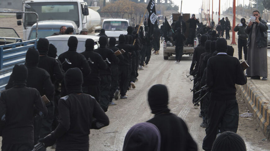 Fighters of al-Qaeda linked Islamic State of Iraq and the Levant parade at the Syrian town of Tel Abyad, near the border with Turkey January 2, 2014. Picture taken January 2, 2014.  REUTERS/Yaser Al-Khodor (SYRIA - Tags: POLITICS CIVIL UNREST CONFLICT) - RTX170UO