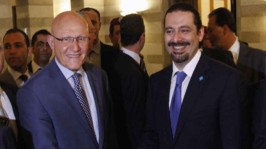 Lebanon's Prime Minister Tammam Salam (L) shakes hands with former Lebanese prime minister Saad al-Hariri upon his arrival at the government's headquarters in Beirut August 8, 2014. Hariri arrived back in Lebanon on Friday for the first time in three years, a visit seen as reasserting his leadership over the Sunni community after a deadly incursion by Islamist militants in the northeast. REUTERS/Georges Farah (LEBANON - Tags: POLITICS) - RTR41O2O