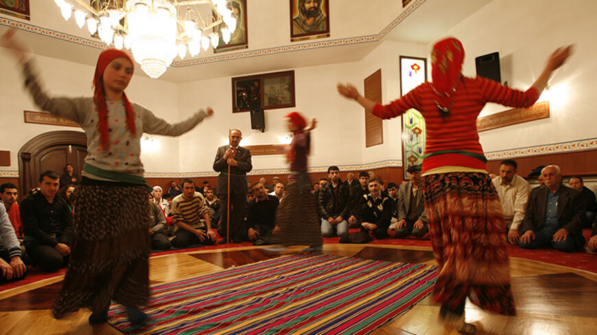 Alevis dance during a prayer in a Cem house in Istanbul April 3, 2008. A court struggle to end mandatory religious instruction in Turkish schools has united Turkey's largest religious minority Alevis and has called into question the ruling AK Party's democratic commitments. Picture taken on April 3, 2008. REUTERS/Umit Bektas (TURKEY)   BEST QUALITY AVAILABLE - RTR2ACQU