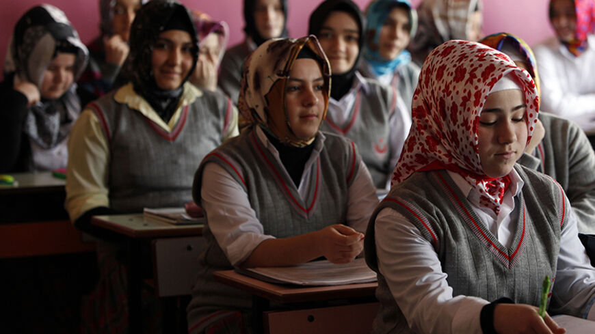 Turkish girls attend a class at the Kazim Karabekir Girls' Imam-Hatip School in Istanbul February 10, 2010. The imam-hatip network is a far cry from the western stereotype of the madrassa as an institution that teaches the Koran by rote and little else. Originally founded to educate Muslim religious functionaries in the 1920s, the imam-hatip syllabus devotes only around 40 percent of study to religious subjects like Arabic, Islamic jurisprudence and rhetoric. The rest is given over to secular topics.  To ma