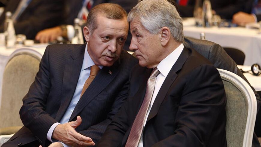Turkey's Prime Minister Tayyip Erdogan (L) chats with Atlantic Council Chairman Chuck Hagel during the Black Sea Energy and Economic Forum in Istanbul November 17, 2011. Turkey's demand for energy will increase by 6-7 percent each year until 2023 and renewable energy projects will meet almost a quarter of total consumption by then, Erdogan said on Thursday. REUTERS/Murad Sezer (TURKEY  - Tags: POLITICS ENERGY) - RTR2U4IB