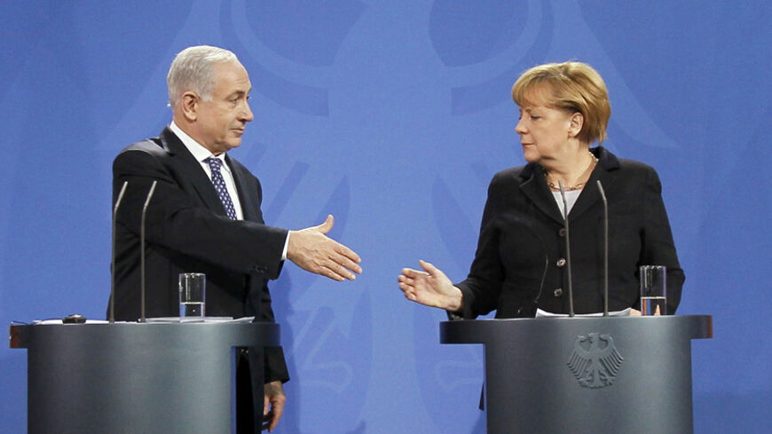 German Chancellor Angela Merkel goes to shake hands with Israeli Prime Minister Benjamin Netanyahu (L) during a news conference after bilateral talks at the Chancellery in Berlin December 6, 2012. Merkel and Netanyahu agreed to disagree on the question of Israeli plans to build more Jewish settlements, the chancellor said on Thursday.    REUTERS/Wolfgang Rattay (GERMANY  - Tags: POLITICS TPX IMAGES OF THE DAY) - RTR3B9OU
