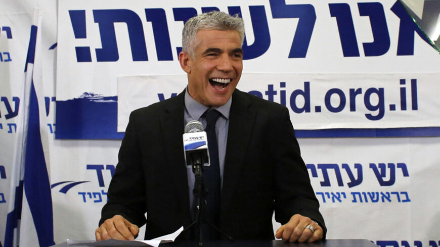 Yair Lapid, leader of the Yesh Atid (There is a Future) party, addresses supporters at his party's headquarters in Tel Aviv January 23, 2013. The surprise star of Israel's election on Tuesday is Lapid, a former television news anchor whose centrist party, exit polls showed, soared to second place in the balloting only months after he joined politics. REUTERS/Ammar Awad (ISRAEL - Tags: POLITICS ELECTIONS TPX IMAGES OF THE DAY) - RTR3CTCL