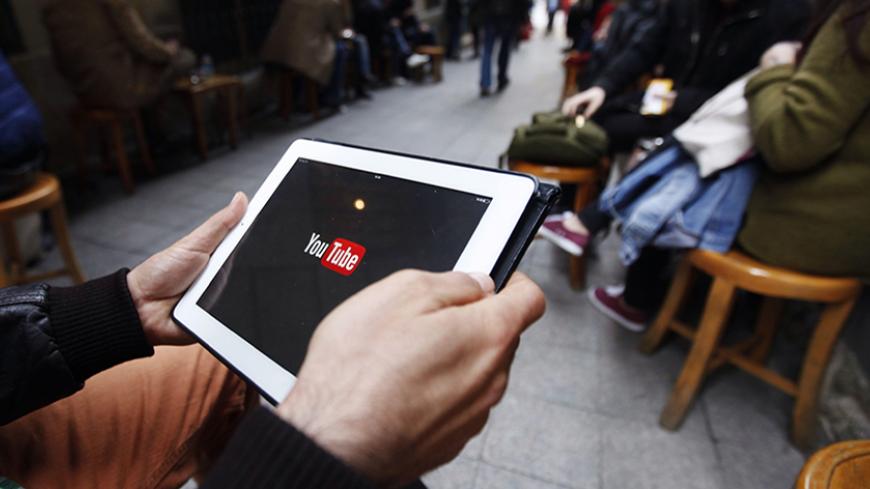 A man tries to get connected to the youtube web site with his tablet at a cafe in Istanbul March 27, 2014. The Turkish telecoms authority TIB said on Thursday it had taken an "administrative measure" against YouTube, a week after it blocked access to microblogging site Twitter. REUTERS/Osman Orsal (TURKEY - Tags: POLITICS CIVIL UNREST SCIENCE TECHNOLOGY) - RTR3IUSP
