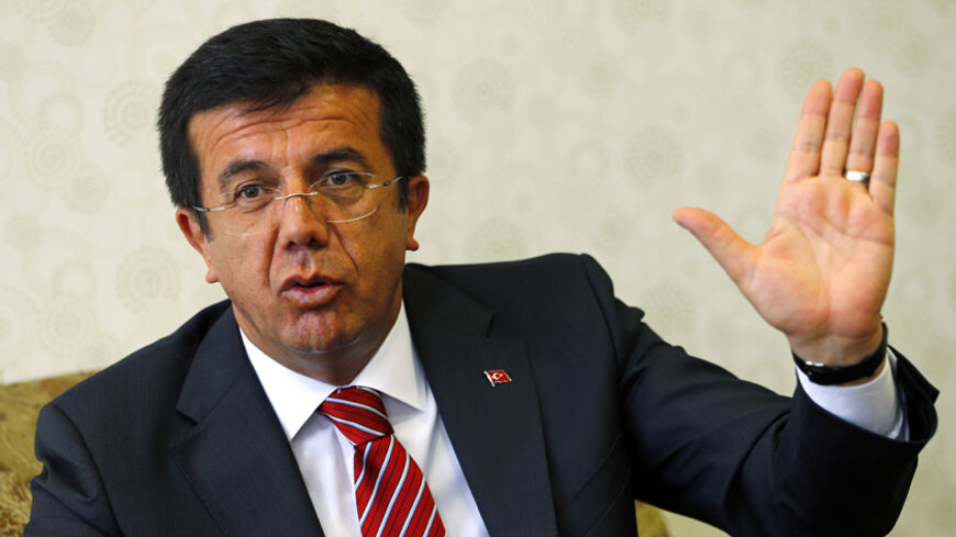 Turkey's Economy Minister Nihat Zeybekci speaks during an interview with Reuters in Ankara August 11, 2014. Turkey's government will maintain its calls for lower interest rates following Prime Minister Tayyip Erdogan's victory in the country's first direct presidential election, the economy minister said on Monday. Zeybekci told Reuters in an interview that the central bank's core mandate for price stability should be expanded to include employment and growth, although he added this would not be a top prior