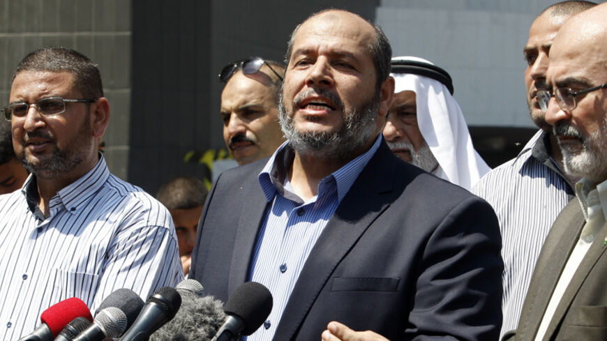 Senior Hamas leader Khalil al-Hayya (C) speaks to the media upon his return to Gaza City from truce talks in Cairo August 14, 2014. A renewed truce between Israel and Hamas appeared to be holding on Thursday despite a shaky start, after both sides agreed to give Egyptian-brokered talks more time to try to end the Gaza war. REUTERS/Ahmed Zakot (GAZA - Tags: POLITICS CIVIL UNREST) - RTR42EMW