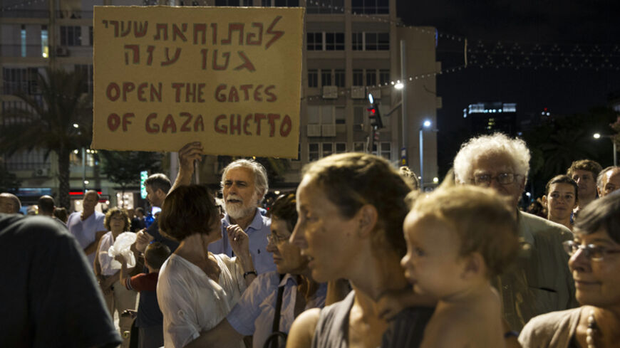A man holds up a placard during a peace rally in Tel Aviv's Rabin Square August 16, 2014. The protesters were demonstrating in favour of a peaceful political agreement, to end the month-long conflict in Gaza, between the Israeli and Palestinian governments. 
REUTERS/Baz Ratner (ISRAEL - Tags: POLITICS CIVIL UNREST) - RTR42O65