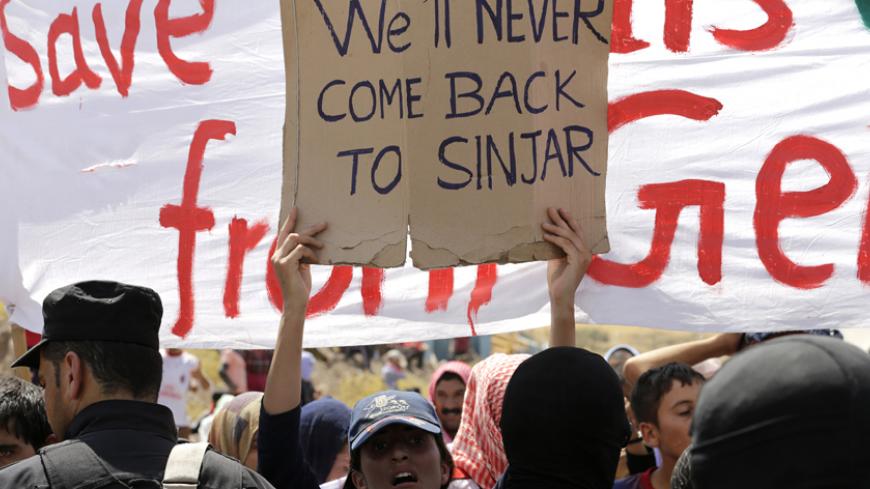 Displaced people from the minority Yazidi sect, who fled the violence in the Iraqi town of Sinjar, take part in a demonstration at the Iraqi-Turkish border crossing in Zakho district of the Dohuk Governorate of the Iraqi Kurdistan province August 17, 2014. Demonstrators demanded protection and evacuation from Iraq to safer areas such as Europe and the United States. Iraq has been plunged into its worst violence since the peak of a sectarian civil war in 2006-2007, with Sunni fighters led by the Islamic Stat