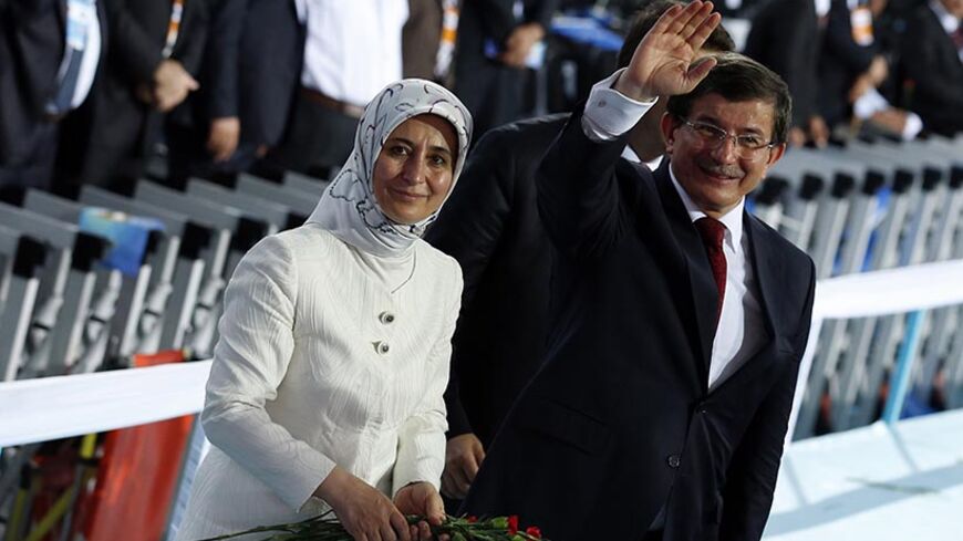 Turkey's Foreign Minister Ahmet Davutoglu and his wife Sare Davutoglu greet their supporters during the Extraordinary Congress of the ruling AK Party (AKP) to choose a new leader of the party, ahead of his inauguration as president, in Ankara August 27, 2014. Davutoglu was elected leader of Turkey's ruling AK Party on Wednesday in a televised ceremony, ahead of his expected appointment as prime minister on Thursday after Tayyip Erdogan is sworn in as president.
  REUTERS/Umit Bektas (TURKEY - Tags: POLITICS